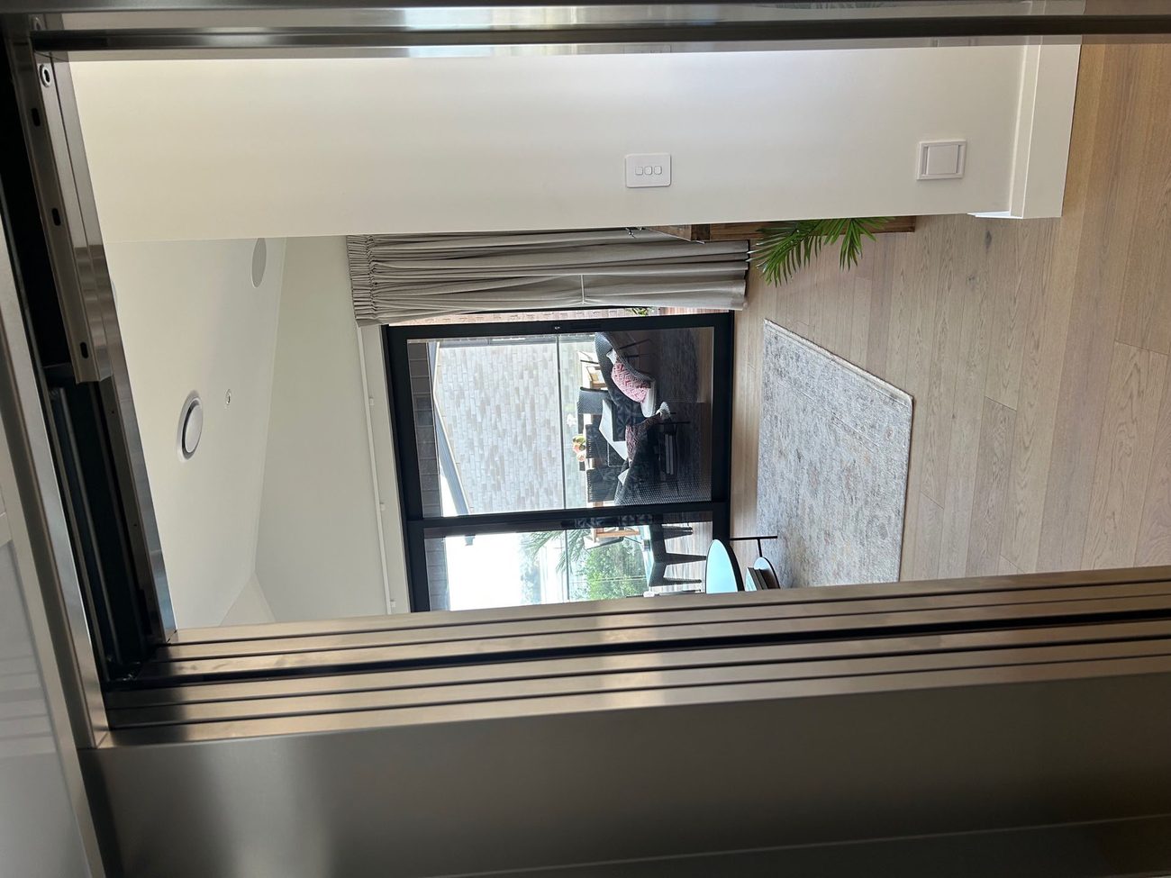 Glass Legacy Home Lift beside a staircase